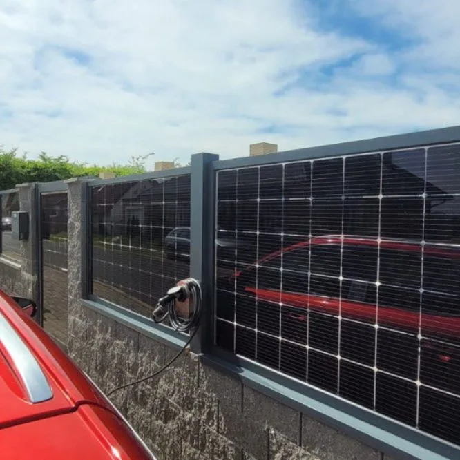 Wallbox on a fence fitted with solar panels